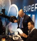 Hines Ward goes over production notes before a Superbowl broadcast (Courtesy of Andrew Ree)