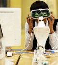 A student tries out Samsung Electronics' Gear products at one of the technology giant's shop in Seoul, Thursday. Samsung Electronics has recently vowed to overhaul its handset lineup as its smartphone sales are on the decline amid tougher competition from Apple and Chinese rivals. (AP/Yonhap)