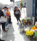 Mourners gather in front of OK Liquor in Los Angeles' Koreatown following Owner Lee Young-ok's death Thursday. (Park Sang-hyuk/The Korea Times)