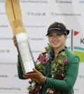 Kyu Jung Baek of South Korea poses with the trophy for the media after winning the KEB Hana Bank Championship golf tournament at Sky72 Golf Club in Incheon, South Korea, Sunday, Oct. 19, 2014. (AP Photo/Ahn Young-joon)