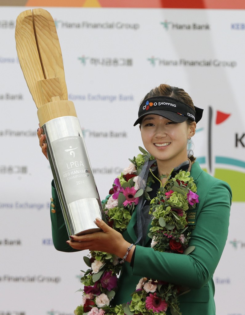 Baek Kyu-jung of South Korea poses with the trophy for the media after winning the KEB Hana Bank Championship golf tournament at Sky72 Golf Club in Incheon, South Korea, Sunday, Oct. 19, 2014. (AP Photo/Ahn Young-joon)