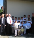 KYCC and Dunn-Edwards Paint Vice President Tim Bosveld, far right, celebrate the completion of a repainting of a low-income apartment in Koreatown Tuesday.