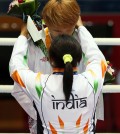 Sarita Devi slips the bronze medal around South Korea’s silver medalist Park Jin-a’s neck. The Korean appeared too stunned to immediately react. (Yonhap)