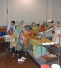 Volunteers make kimchi during the Northern California JABI Charity Association's event to give away free bottles to the area's elderly.