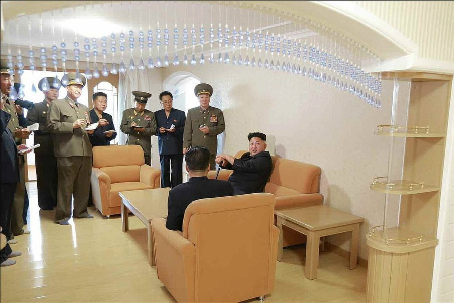 North Korean leader Kim Jong-un with a cane sits on a couch during a visit to a faculty flat at the Kim Chaek University of Technology in Pyongyang. (KCNA-Yonhap)