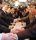 National Security Office chief Kim Kwan-jin, left, shakes hands with North Korea's National Defense Commission Vice Chairman Hwang Pyong-so during the northern delegation's visit to Incheon in Octover. Hwang was accompanied by Choe Ryong-hae, first on the right, and Kim Yang-gon, third on the right, both secretaries in the reclusive regime's ruling Workers' Party.  (Yonhap)