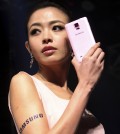 A Taiwanese model perform Samsung Note4 during Samsung's media event in Taipei, Taiwan, Monday, Sept. 30, 2014. The Samsung Galaxy Note4 sells for NT$24,900, US$ 815 in Taiwan.(AP Photo/Chiang Ying-ying)