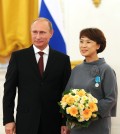 Russia's president Vladimir Putin (L) awards Sun-Min Kim, the general director of the Pushkin House Russian Culture and Education Centre in South Korea, with the Pushkin Medal at a ceremony of presenting state decorations to foreign citizens for strengthening friendship and cooperation with Russia. (Yonhap)