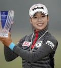 South Korean golfer Lee Mi-hyang holds up her trophy after winning her first LPGA Tour victory at the Mizuno Classic held at Kintetsu Kashikojima Country Club in Shima, Japan on Nov. 9, 2014. (Yonhap)