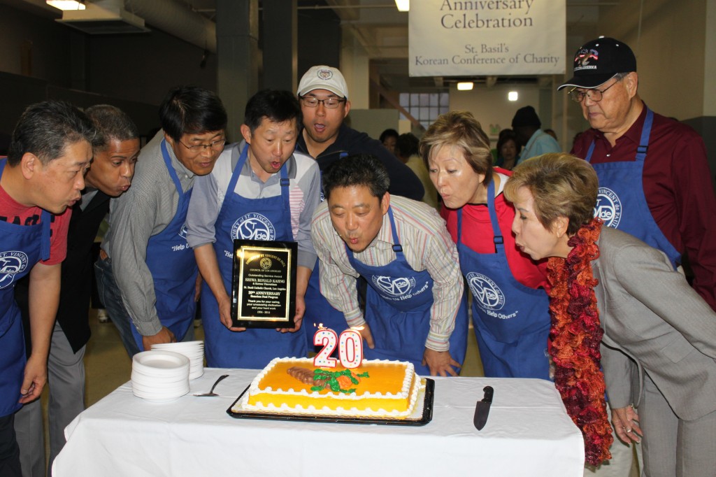 Korean Vincentians and SVDP-LA officials blow out candles on the 20th anniversary cake.