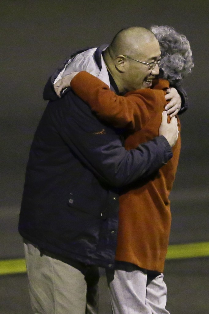 Kenneth Bae, left, who had been held in North Korea since 2012, hugs his mother Myunghee Bae after arriving, Saturday, Nov. 8, 2014, at Joint Base Lewis-McChord, Wash., after they were freed during a top-secret mission by James Clapper, U.S. director of national intelligence. (AP Photo/Ted S. Warren)