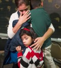 Isela Segovia hugs her two children Nivia, 7, bottom,  and Elian, 6, while watching President Obama's speech as it is televised Thursday, Nov. 20, 2014, in Houston. Obamas sweeping changes to the U.S. immigration system could shield nearly 5 million people here illegally from deportation, without going through Congress. (AP Photo/Houston Chronicle, J. Patric Schneider)