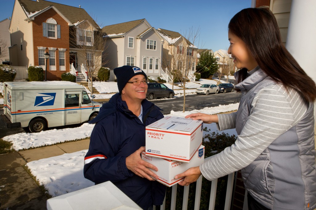 U.S. Postal Service letter carrier delivering packages during the holidays (PRNewsFoto/U.S. Postal Service) 