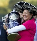 Christina Kim holds her trophy after winning the Lorena Ochoa Invitational LPGA golf tournament in Mexico City, Sunday, Nov. 16, 2014. Kim won the Invitational on Sunday for her first LPGA Tour title in nine years, beating China's Shanshan Feng in a playoff after blowing a five-stroke lead in the final round. (AP Photo/Christian Palma)
