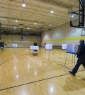 A voter heads to a voting booth with his ballot in hand at Speedway High School, Speedway, Ind., Tuesday, Nov. 4, 2014.  Record-low voter turnout could be the most notable development of the day as California is not faring much better. (AP Photo/Doug McSchooler)