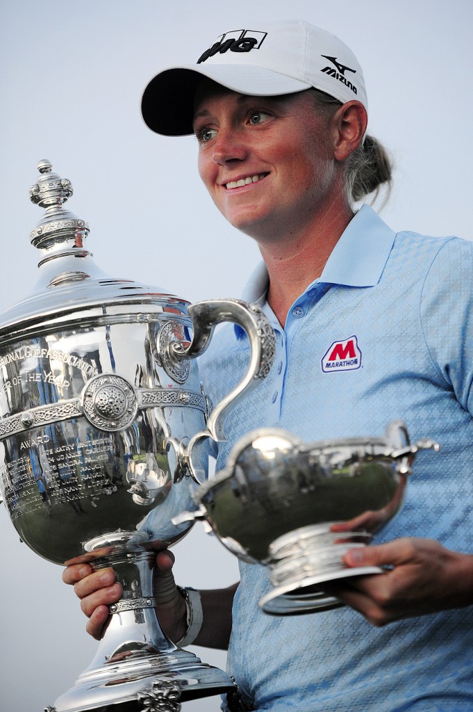 Stacy Lewis holds up her trophies for the media on hole 18, Sunday, Nov. 23, 2014 at the Tiburon Golf Club at the Ritz-Carlton Golf Resort in Naples, Fla. Lewis won LPGA Player of the Year and Vare trophies. This was her second consecutive Bare Trophy. She's the first American to win stroke average, money and POY since Betsy King in 1993. Today marked the final round of the LPGA's CME Group Tour Championship. Lydia Ko of New Zealand defeated Carlota Ciganda of Spain in a four-hole playoff. (AP Photo/Naples Daily News, Corey Perrine)