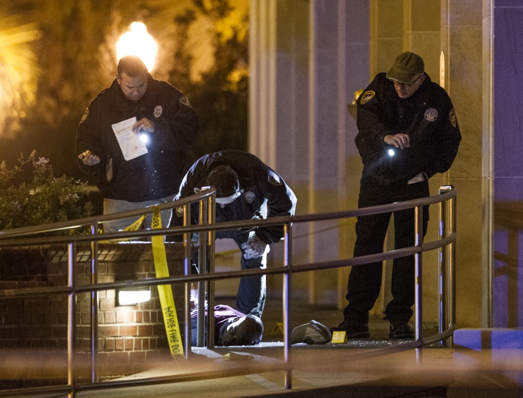 Tallahassee police investigate the scene of a shooting outside the Strozier library on the Florida State University campus in Tallahassee, Fla. Thursday Nov 20, 2014. Officers shot and killed the suspected gunman police said. It has been confirmed by authorities that the body in this image is that of the dead gunman. There were no other fatalities in the shooting. (AP Photo/Mark Wallheiser)