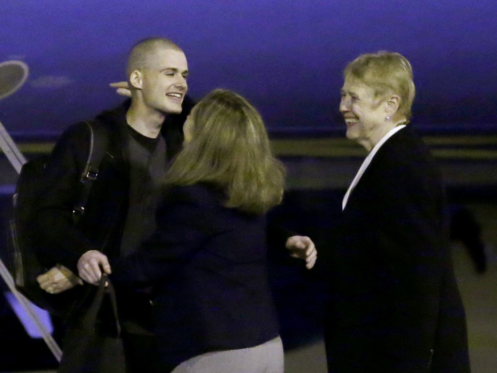 Matthew Miller, left, who had been held in North Korea since April, 2014, is greeted after arriving Saturday, Nov. 8, 2014, at Joint Base Lewis-McChord, Wash., after he were freed during a top-secret mission. (AP Photo/Ted S. Warren)