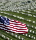 A U.S. Flag flies over war veterans tombstones at Golden Gate National Cemetery in San Bruno, Calif. (AP)