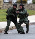 Police move near the scene of a shooting Monday, Dec. 15, 2014, in Souderton, Pa. Police are surrounding a home in Souderton, outside Philadelphia, where a suspect is believed to have barricaded himself after shootings at multiple homes. Police tell WPVI-TV the man is suspected of killing a five people Monday morning at three different homes northwest of Philadelphia.  (AP Photo/Matt Rourke)