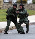 Police move near the scene of a shooting Monday, Dec. 15, 2014, in Souderton, Pa. Police are surrounding a home in Souderton, outside Philadelphia, where a suspect is believed to have barricaded himself after shootings at multiple homes. Police tell WPVI-TV the man is suspected of killing a five people Monday morning at three different homes northwest of Philadelphia.  (AP Photo/Matt Rourke)