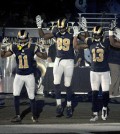In this Sunday Nov. 30, 2014, file photo, St. Louis Rams players, from left; Stedman Bailey (12), Tavon Austin (11), Jared Cook, (89) Chris Givens (13) and Kenny Britt (81) raise their arms in awareness of the events in Ferguson, Mo.,  as they walk onto the field during introductions before an NFL football game against the Oakland Raiders in St. Louis. Time will tell whether the ``hands-up'' gesture during pregame introductions will leave a lasting memory or simply go down as a come-and-go moment in the age of the 24-hour news cycle. Either way, it certainly isn't the first time high-profile athletes have used their platform to make political statements. (AP Photo/L.G. Patterson, File)
