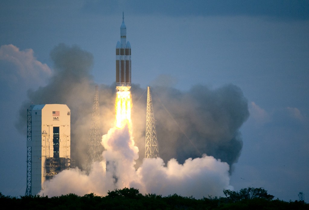 The NASA Orion space capsule atop a Delta IV rocket, in its first unmanned orbital test flight, lifts off from the Space Launch Complex 37B pad at the Cape Canaveral Air Force Station,  Friday, Dec. 5, 2014, in Cape Canaveral, Fla. (AP Photo/John Raoux)