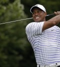 In his last tournament on Aug. 8, 2014, Tiger Woods winces after tee shot on the sixth hole during the second round of the PGA Championship golf tournament at Valhalla Golf Club in Louisville, Ky. The last time Tiger Woods was seen at a golf tournament was at the PGA Championship when he missed the cut. He returns this week at the Hero World Challenge in Windermere, Fla.  (AP Photo/Jeff Roberson, File)