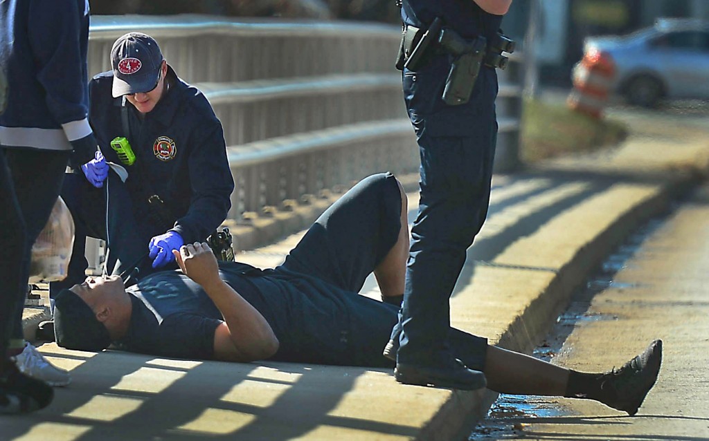A Charlotte firefighter tends to Carolina Panthers NFL football quarterback Cam Newton following a two-vehicle crash not far from the team's stadium in Charlotte, N.C., Tuesday, Dec. 9, 2014. (AP Photo/The Charlotte Observer, Todd Sumlin)