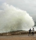 Aidan Stephenson,12, and Conor Stephenson,10, visiting from Phoenix, watch the waves break on Ocean View Blvd., Wednesday, Dec. 10, 2014, in Pacific Grove, Calif. Northern California residents are bracing for a powerful storm that could be the biggest in five years and which prompted the National Weather Service to issue a high wind and flash flood warning. The storm is expected to arrive Wednesday and pelt the region through Thursday. (AP Photo/Monterey Herald, Vern Fisher)