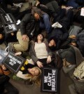 Protesters rallying against a grand jury's decision not to indict the police officer involved in the death of Eric Garner stage a "die-in" at the Apple Store on Fifth Avenue, Friday, Dec. 5, 2014, in New York. (AP Photo/Jason DeCrow)