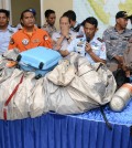 Commander of Indonesian Air Force 1st Operational Command Rear Marshall Dwi Putranto, center, shows the airplane parts and a suitcase found floating on the water near the site where AirAsia flight QZ 8501 disappeared, during a press conference at the airbase in Pangkalan Bun, Central Borneo, Indonesia, Tuesday, Dec. 30, 2014. Bodies and debris seen floating in Indonesian waters Tuesday, painfully ending the mystery of AirAsia Flight QZ8501, which crashed into the Java Sea and was lost to searchers for more than two days. (AP Photo/Dewi Nurcahyani)