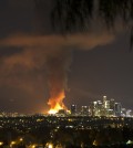 A massive fire engulfed an apartment building construction site near downtown Los Angeles on Monday, Dec. 8, 2014. Crews battled two large fires in Los Angeles early Monday, including a massive one downtown that closed portions of two major freeways and blanketed the area in ash and heavy smoke. (AP Photo/Nancy Yuille)