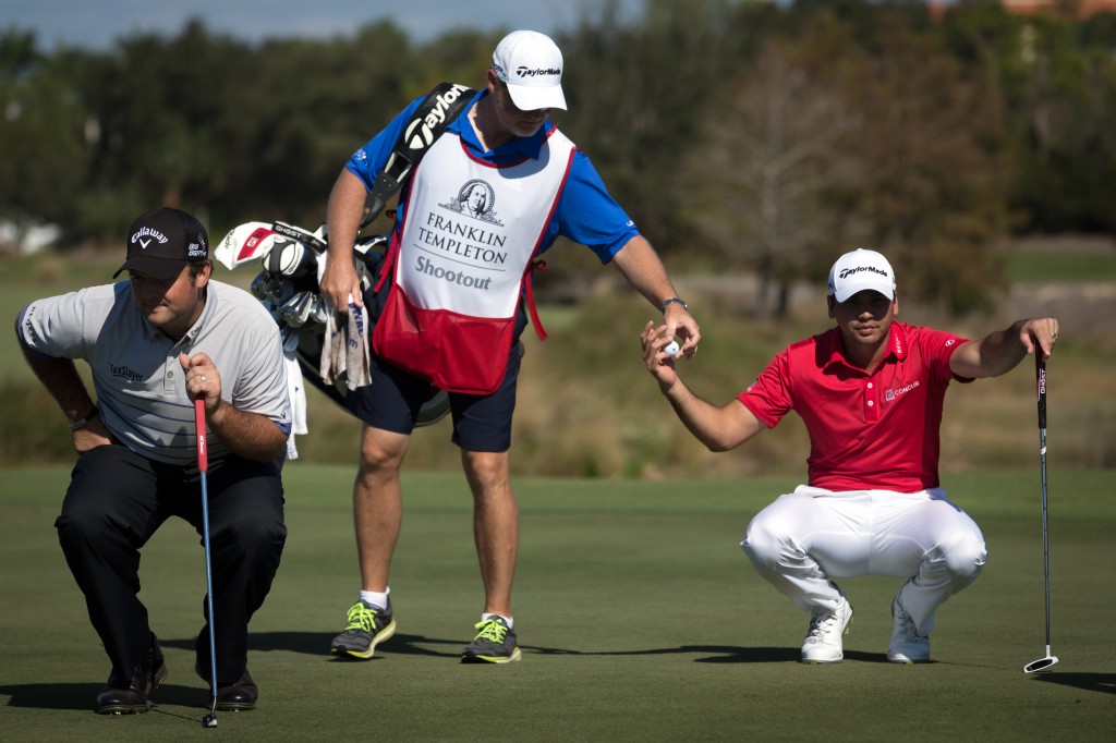 PGA golf pro Jason Day, right, prepares to putt on the 11th green during the first day of the Franklin Templeton Shootout on Thursday, Dec. 11, 2014, at the Tiburon Golf Club in Naples, Fla. Day finished in first place for the day with teammate Cameron Tringale at 17-under-par. (AP Photo/Naples Daily News, David Albers)