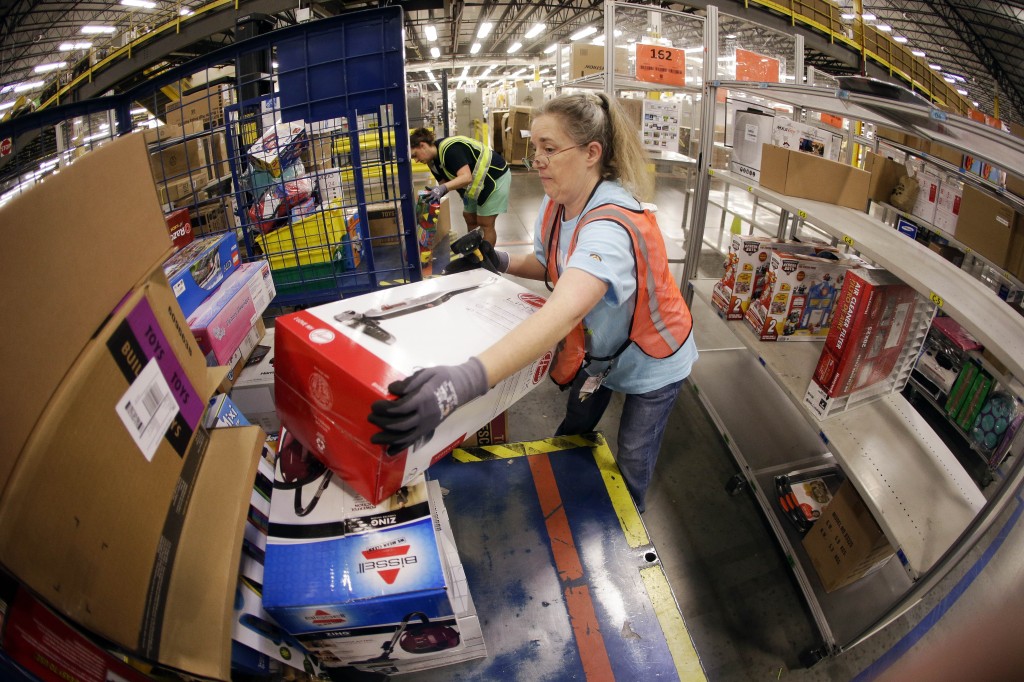 Teresa Clark fills an order at the Amazon fulfillment center in Lebanon, Tenn. on Monday, Dec. 1, 2014. Retailers rolled out discounts and free shipping deals on Cyber Monday, with millions of Americans expected to log on and shop on their work computers, laptops and tablets after the busy holiday shopping weekend. (AP Photo/Mark Humphrey)