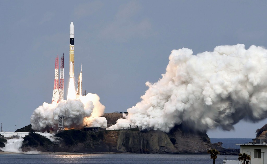 An H2-A rocket carrying space explorer Hayabusa2, lifts off from a launching pad at Tanegashima Space Center in Kagoshima, southern Japan, Wednesday, Dec. 3, 2014. The Japanese space explorer was launched Wednesday on a six-year roundtrip journey to blow a crater in a remote asteroid and collect samples from inside in hopes of gathering clues to the origin of earth. (AP Photo/Kyodo News) 