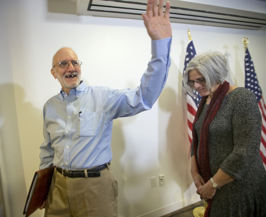 Alan Gross, waves as he and his wife Judy leave following his statement at his lawyer's office in Washington, Wednesday, Dec. 17, 2014. Gross was released from Cuba after 5 years in a Cuban prison. (AP Photo/Pablo Martinez Monsivais)