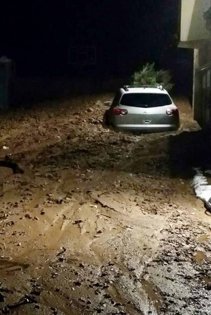 This photo provided by the Glendora Police Department shows a driveway covered in mud in a neighborhood of the suburb of Glendora, Calif. on Friday, Nov. 21, 2014. Rare Southern California rains triggered mudslides in an area of the Los Angeles-area foothills scorched bare by a wildfire earlier this year. Los Angeles County Fire Department Dispatch Supervisor Robert Diaz says a 4-foot-high flow of debris hit a home in the suburb before dawn. (AP Photo/Glendora Police Department)