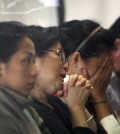 Relatives and next-of-kin of passengers on the AirAsia flight QZ8501wait for the latest news on the search of the missing jetliner at Juanda International Airport in Surabaya, East Java, Indonesia, Monday, Dec. 29, 2014. Search planes and ships from several countries on Monday were scouring Indonesian waters over which an AirAsia jet disappeared, more than a day into the region's latest aviation mystery. AirAsia Flight 8501 vanished Sunday in airspace thick with storm clouds on its way from Surabaya, Indonesia, to Singapore. (AP Photo/Trisnadi Marjan)