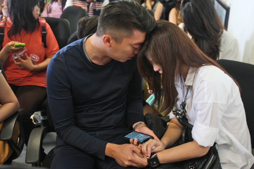 Relatives of the passengers of AirAsia flight QZ8501 comfort each other at Juanda International Airport in Surabaya, East Java, Indonesia, Sunday, Dec. 28, 2014. The AirAsia plane with 161 people on board lost contact with ground control on Sunday while flying over the Java Sea after taking off from a provincial city in Indonesia for Singapore, and search and rescue operations were underway. (AP Photo/Trisnadi)