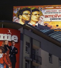 A banner for "The Interview"is posted outside Arclight Cinemas, Wednesday, Dec. 17, 2014, in the Hollywood section of Los Angeles. A U.S. official says North Korea perpetrated the unprecedented act of cyberwarfare against Sony Pictures that exposed tens of thousands of sensitive documents and escalated to threats of terrorist attacks that ultimately drove the studio to cancel all release plans for the film at the heart of the attack, "The Interview." (AP Photo/Damian Dovarganes)