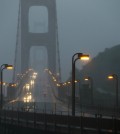 Traffic moves slowly across the Golden Gate Bridge in the high winds and rain Thursday, Dec. 11, 2014, in this view from Sausalito, Calif.  A storm expected to be one of the windiest and rainiest in five years swept across the San Francisco Bay Area on Thursday, knocking out power to tens to thousands and delaying travel by air, train and ferry. Pacific Gas & Electric is reporting outages are widespread across the Bay Area due to weather, but officials weren't immediately available to give a specific number of outages.(AP Photo/Eric Risberg)