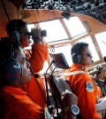 Crew of Indonesian Air Force C-130 airplane of the 31st Air Squadron scan the horizon during a search operation for the missing AirAsia flight 8501 jetliner over the waters of Karimata Strait in Indonesia, Monday, Dec. 29, 2014. Search planes and ships from several countries on Monday were scouring Indonesian waters over which the AirAsia jet disappeared, more than a day into the region's latest aviation mystery. Flight 8501 vanished Sunday in airspace thick with storm clouds on its way from Surabaya, Indonesia, to Singapore. (AP Photo/Dita Alangkara)