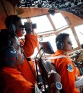 Crew of Indonesian Air Force C-130 airplane of the 31st Air Squadron scan the horizon during a search operation for the missing AirAsia flight 8501 jetliner over the waters of Karimata Strait in Indonesia, Monday, Dec. 29, 2014. Search planes and ships from several countries on Monday were scouring Indonesian waters over which the AirAsia jet disappeared, more than a day into the region's latest aviation mystery. Flight 8501 vanished Sunday in airspace thick with storm clouds on its way from Surabaya, Indonesia, to Singapore. (AP Photo/Dita Alangkara)