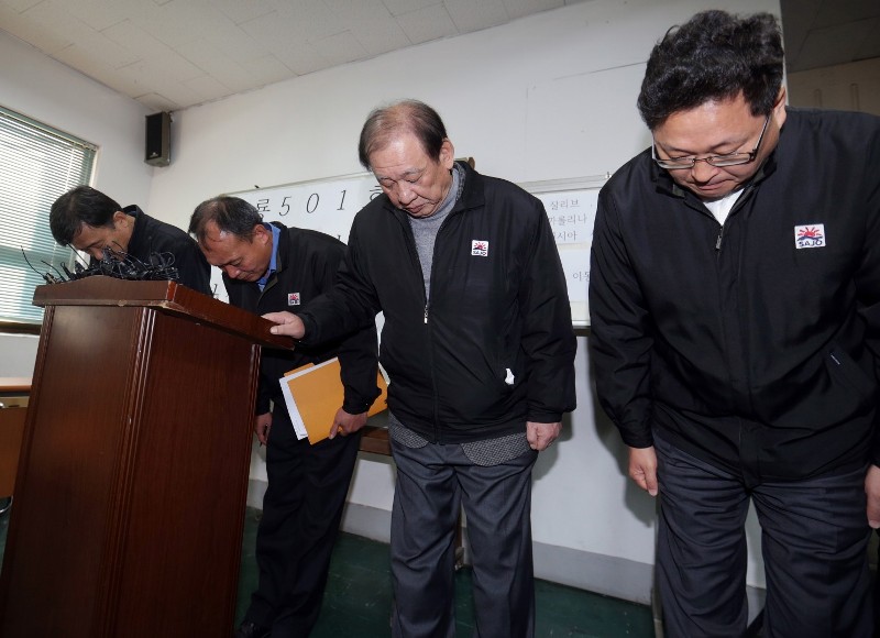 Executives of Sajo Industries bow to families of the missing fishermen of the South Korean fishing boat Oryong 501, which sank in the western Bering Sea on Dec. 1, during a briefing session at the company's branch office in Busan, South Korea, Wednesday, Dec. 3, 2014. (AP Photo/Yonhap, Kim Sun-ho)