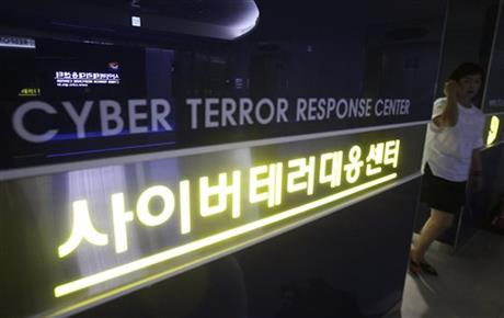 A woman walks by a sign at Cyber Terror Response Center of National Police Agency in Seoul, South Korea. Most North Koreans have never even seen the Internet. But the country Washington suspects is behind a devastating hack on Sony Pictures Entertainment has managed to orchestrate a string of crippling cyber infiltrations of South Korean computer systems in recent years, officials in Seoul believe, despite North Korea protesting innocence. (AP Photo/Ahn Young-joon)
