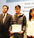 From the left, KSEANY Chairman Stephen Suh standing with the winners of the Mayor's Award, Alex Kim and Jeon Soo-bin. (Korea Times)