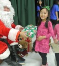 Children receive gifts from Santa at KYCC's carnival Saturday. (Park Ji-hye/The Korea Times)