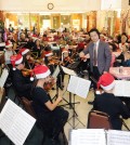 Hayfield Youth Orchestra, led by conductor KIm Yong-jae, performs at Wilshire Day Care Center Monday. (Park Sang-hyuk/The Korea Times)