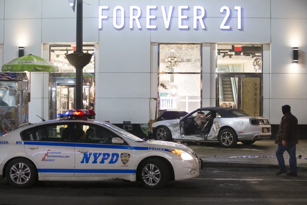 Police stand guard at the scene of a vehicular accident on 34th Street, Thursday, Dec. 11, 2014, in New York. Six people were hurt when the car jumped a curb in midtown Manhattan and struck a group of people around 10 p.m. A fire department spokesman says the injured were taken to Bellevue hospital with serious but non-life threatening injuries. (AP Photo/John Minchillo)